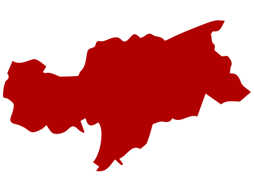 Das Bild ist eine rote Silhouette einer Karte oder Region, die wahrscheinlich ein Land oder eine Region darstellt, mit einem weißen Hintergrund. Die Karte scheint flach zu sein und enthält keinen Text oder andere erkennbare Objekte. Die rote Farbe der Karte hebt sich von dem weißen Hintergrund ab, so dass die Form und der Umriss der Region leicht zu erkennen und zu verstehen sind.